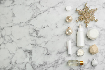Fototapeta na wymiar Flat lay composition with different cosmetic products on white marble table, space for text. Winter care