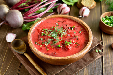 Tasty beetroot soup with sour cream and greens in bowl, borscht