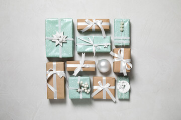Flat lay composition of color Christmas gift boxes on light background