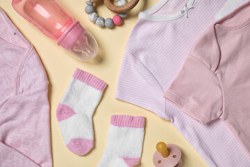Flat lay composition with cute baby items on beige background