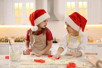 Cute little children making Christmas cookies in kitchen