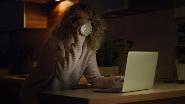 Video of woman drinking coffee and working ah home.  Shot with RED helium camera in 8K.