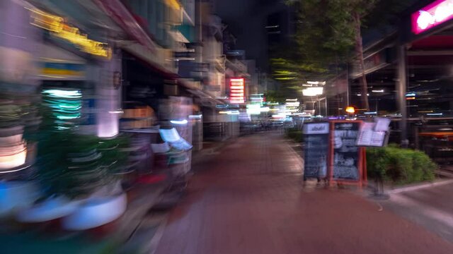 night time illuminated singapore city center crowded restaurant street walking timelapse panorama 4k 