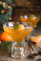 Delicious tangerine jelly on wooden table, closeup
