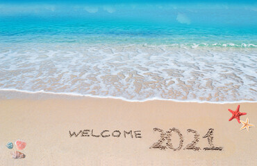 welcome 2021 written on the beach