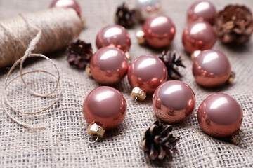 Composition with beautiful Christmas baubles on sacking