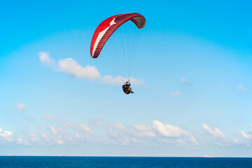 Fototapeta na wymiar Paragliding over the sea. Paragliding sports