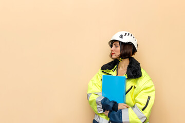 Female industrial worker in hard hat with document folder. Woman engineer with white hard hat. Climber