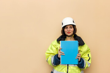 Female industrial worker in hard hat with document folder. Woman engineer with white hard hat. Climber