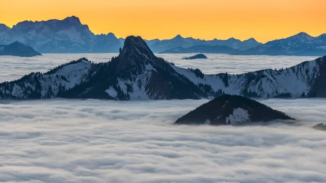 Scenic sunset Mountain Alps time lapse e view of Beautiful mountains and fog at sunset, Sea of fog, fog over mountain in the morning sunrise, Beautiful nature landscape pre alps mountain germany.