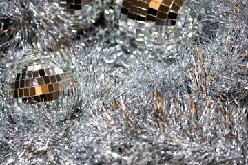 Abstract Christmas background with silver tinsel and mirror disco balls. New Year concept, copy space