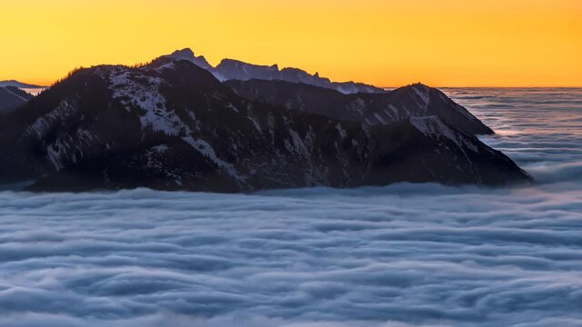 Sunset cloud movements A sea of fog is formed from stratus. Above the clouds over. Flat surface.Alps mountain sunrise time lapse nature landscapes zugspitz, alpspitz mountain.