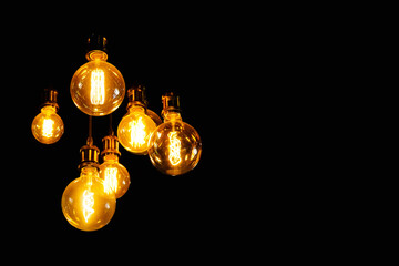 Tungsten lamp with black background for copy space. Old fashioned chandelier, decorative light and lamp.	