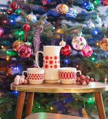 Mid century modern porcelain tea set with red pattern before the christmas tree