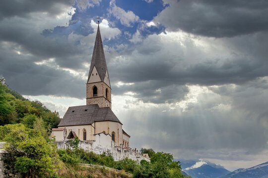 The Church of San Giorgio in Agumes under a dramatic sky, South Tyrol, Italy