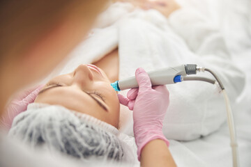 Caucasian patient being treated by a dermatologist