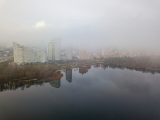 Fototapeta premium Aerial drone view. Low clouds over the Dnieper river in Kiev. Foggy autumn morning.