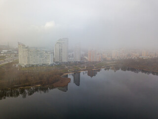 Fototapeta premium Aerial drone view. Low clouds over the Dnieper river in Kiev. Foggy autumn morning.