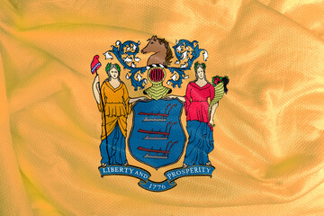 The New Jersey flag is the coat of arms from the Seal of New Jersey on a tan background. The colors...