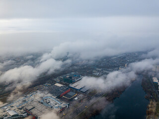 Aerial drone view. Low clouds over the Dnieper river in Kiev. Foggy autumn morning.