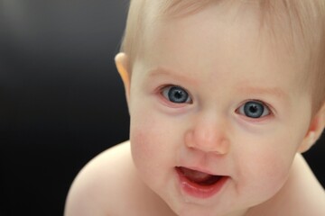 Close-up portrait of smiling  newborn girl