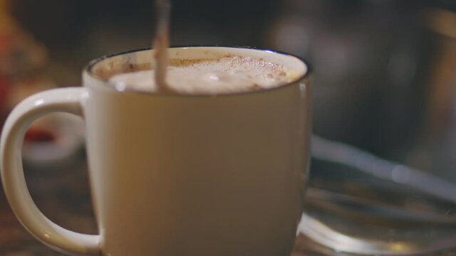 Stirring Hot Choco In A Cup With A Teaspoon - close up