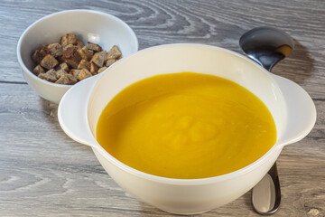 Traditional American pumpkin yellow soup.