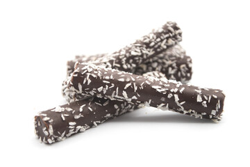 Closeup of chocolate sticks with coconut on white background