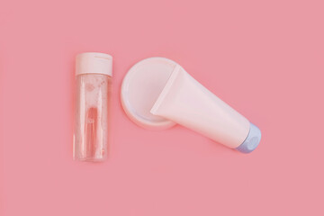 Flat lay with night or day cream,white clay facel mask in jar,cleansing tonic on pink background. Beauty background with facial cosmetic products. Spa concept. Beauty blogger, salon treatments concept