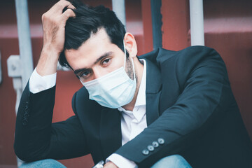 Portrait of man, guy in business suit and combing hair with fingers, brushing hair, wears medical...