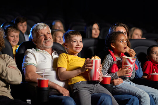 People With Little Kids On Knees In Cinema.