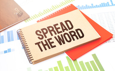 Notepad with text Spread the word. Diagram, red notepad and white background