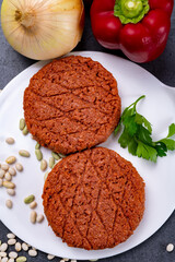 Tasty uncooked burger made with vegetarian plant based imitation minced meat ready for grill
