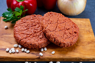 Tasty uncooked burger made with vegetarian plant based imitation minced meat ready for grill
