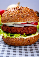 Tasty hamburger made with vegetarian plant based imitation minced meat burger and fresh vegetables