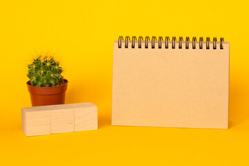 cactus and craft diary with copy space on a yellow background