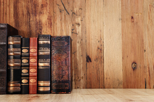 image of antique books over old wooden table