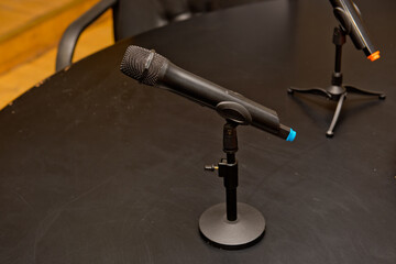 Black radio microphone on the table. Close up.