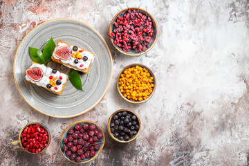 top view delicious cream cakes with different fruits on light background dessert pie sweet color photo