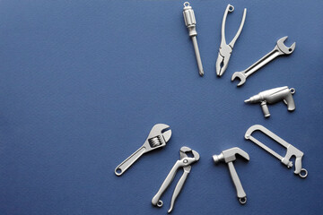 Metal tools lie in a circle. The concept of repair. Construction. Recovery. Repair services. Hammer, wrench, screwdriver. Background for the design.