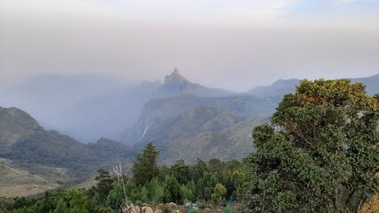 beautiful scenic view from Kodanad View Point of misty rain cloud hill mountain green forest