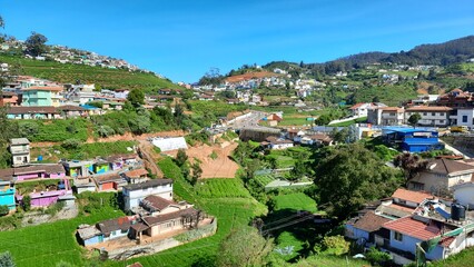 Fototapeta na wymiar beautiful road side view of hill mountain landfall village house town with blue sky clouds background