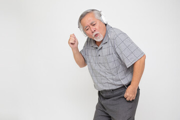Senior Asian man listening music with headphones and dancing isolated on white background