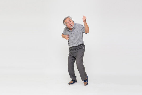 Senior Asian Man Listening Music With Headphones And Dancing Isolated On White Background