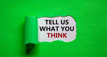 Tell us what you think symbol. Words 'tell us what you think' appearing behind torn green paper. Business and 'tell us what you think' concept. Copy space.