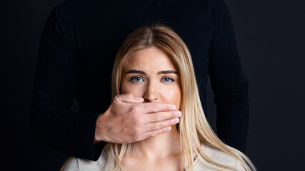 Shut up and listen. Male hand closes woman mouth and prevents her from talking about feelings