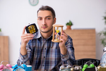 Young male watchmaker working in the workshop