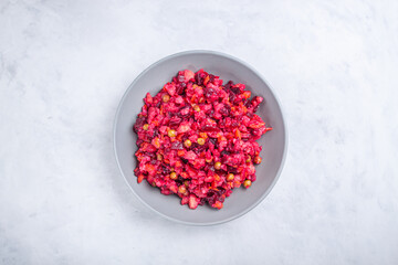 Traditional beetroot russian salad is vinaigrette in bowl