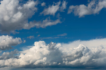 Beautiful blue sky with white cumulus clouds as a natural background