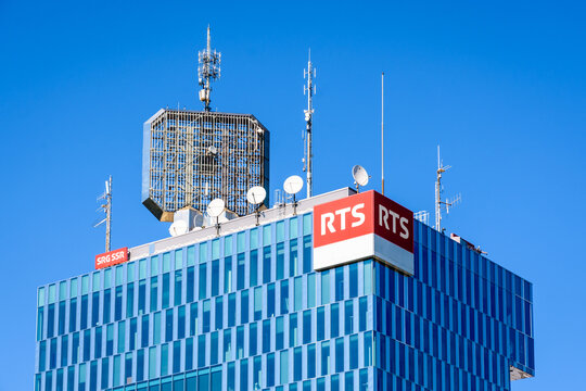 Geneva, Switzerland - September 8, 2020: Close-up view of the top of the tower of the RTS (Radio Television Suisse), the French-speaking Swiss public broadcasting company, with antennas on the roof.